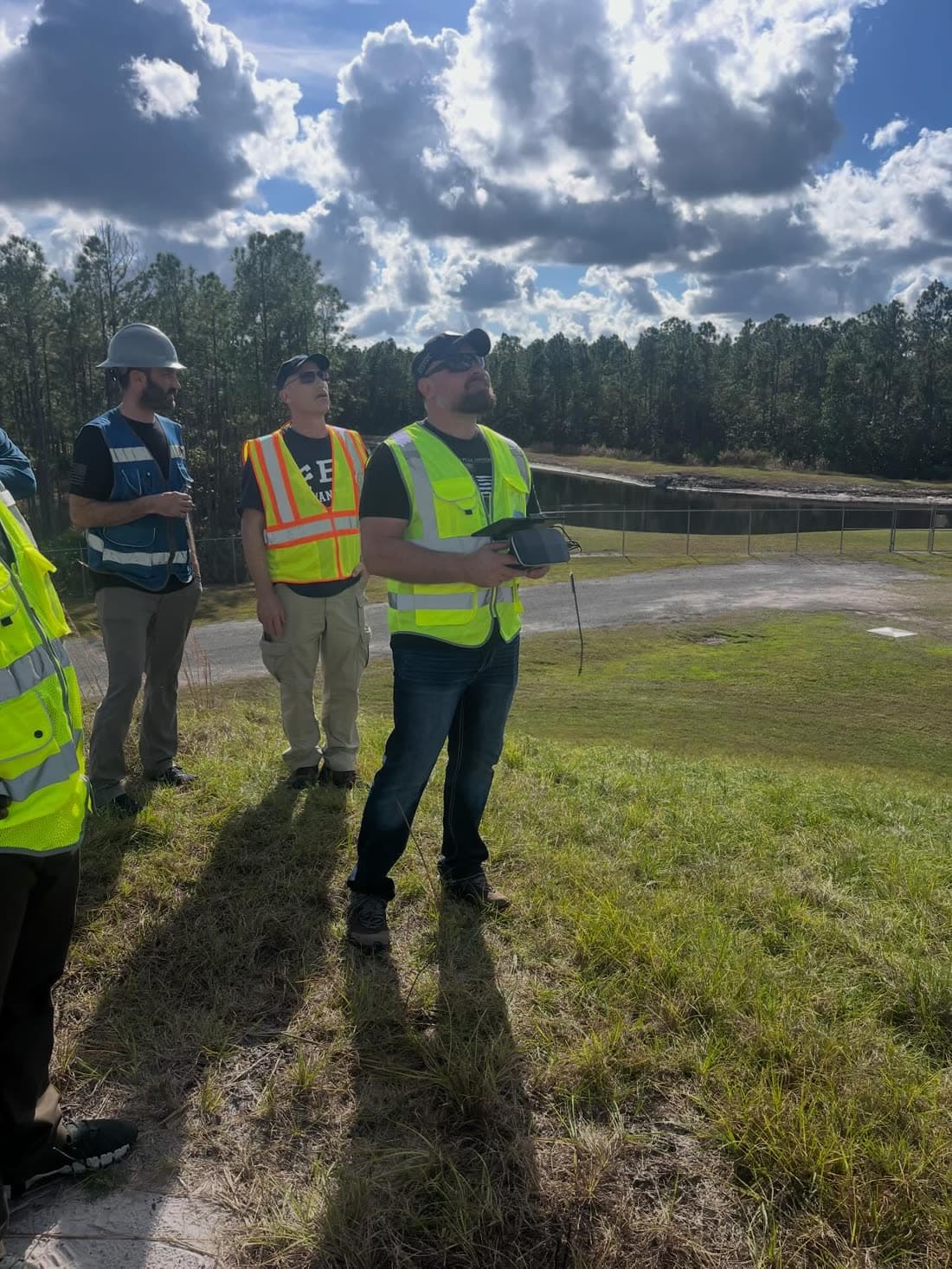 Drone operators working together in the field with a flight controller